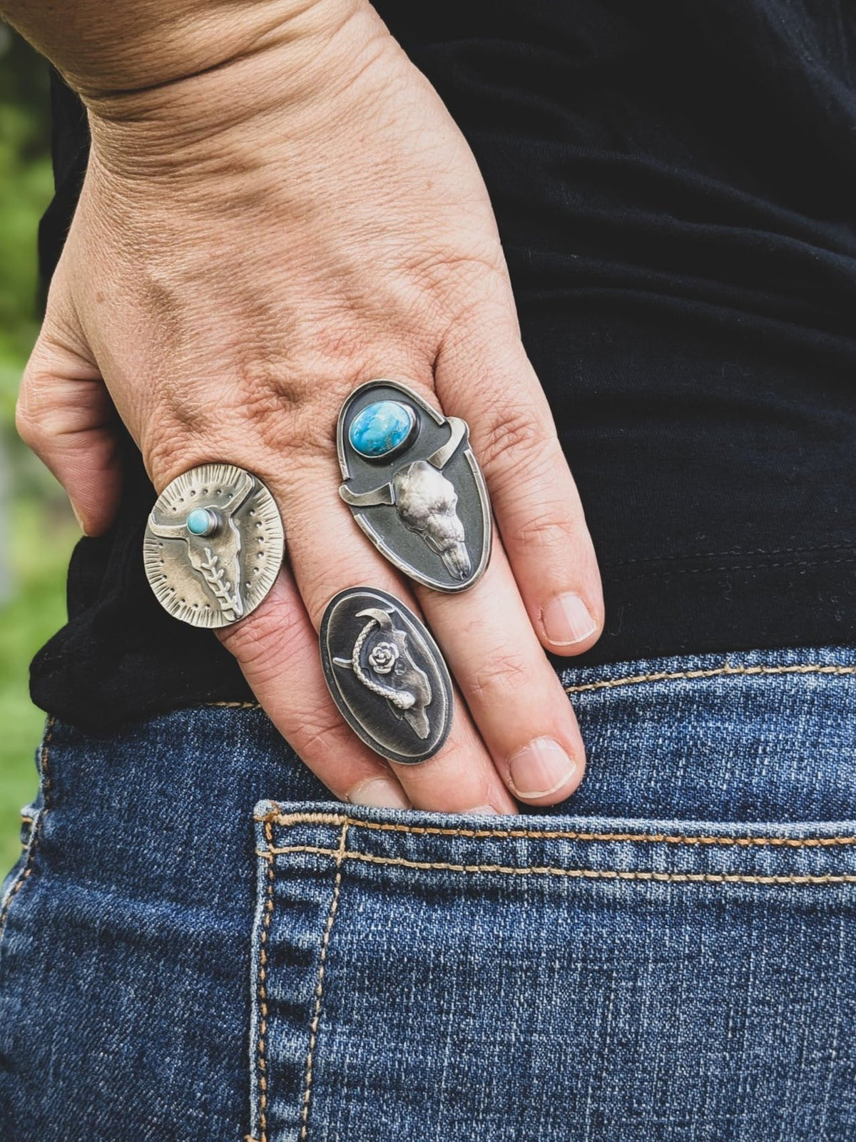 Custom sterling silver rings on person's hand