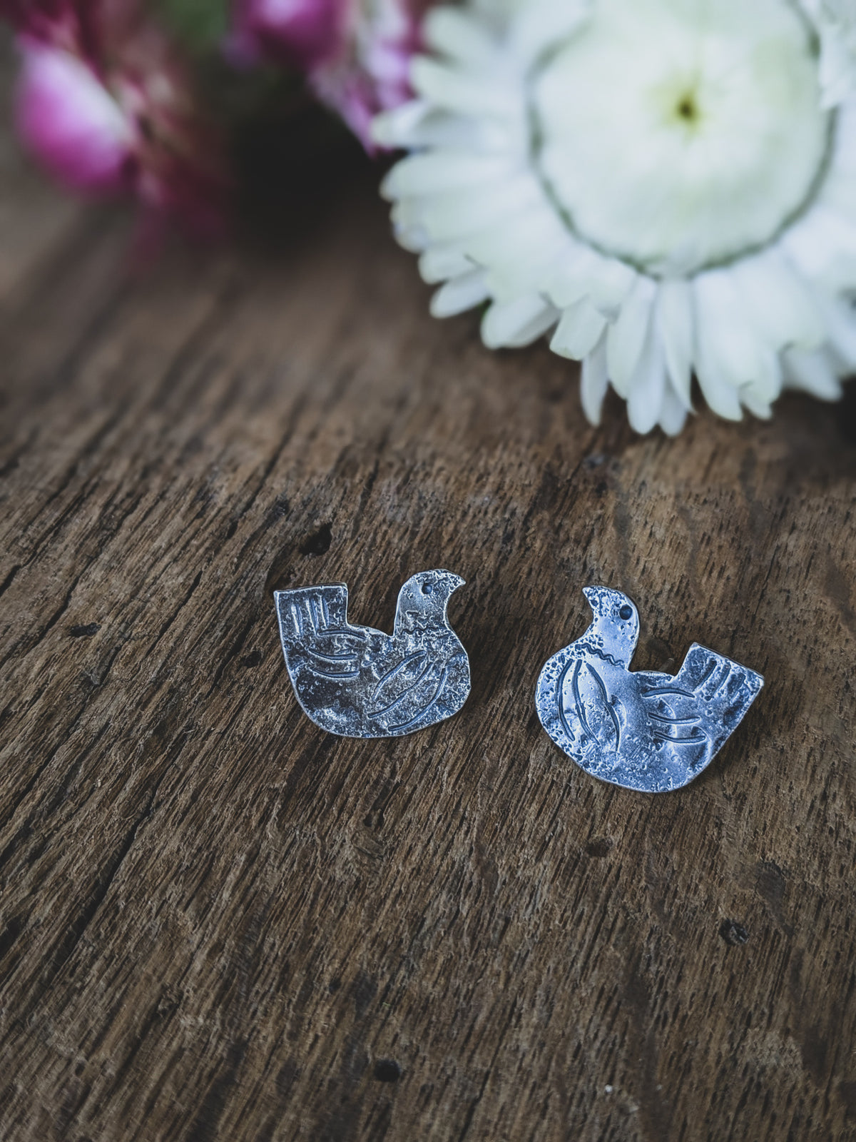chicken stud earrings made of sterling silver with stamping to give a folk art style