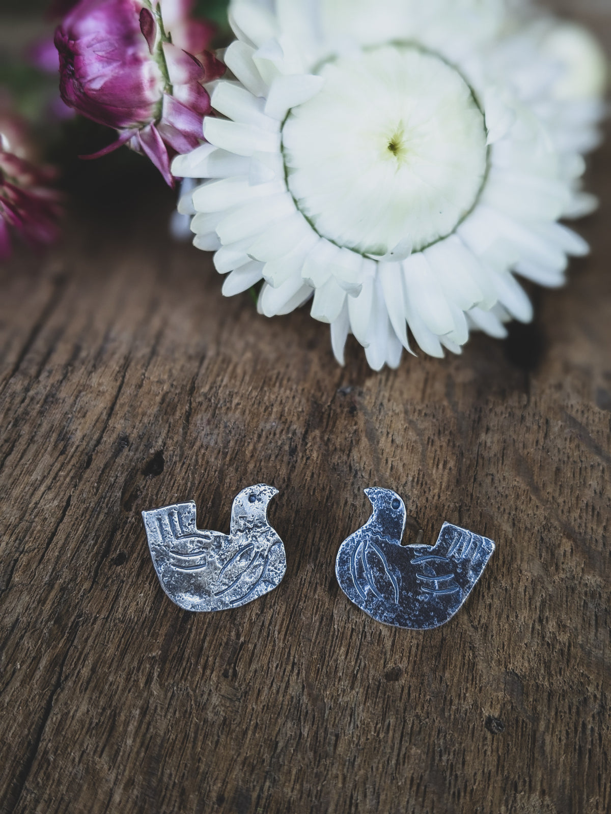 chicken stud earrings made of sterling silver with stamping to give a folk art style